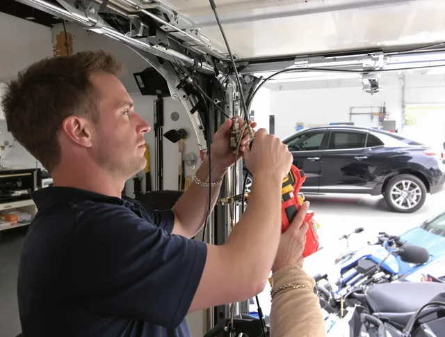 Charlotte Garage Door Repair safety certified technician performing cable replacement in Charlotte