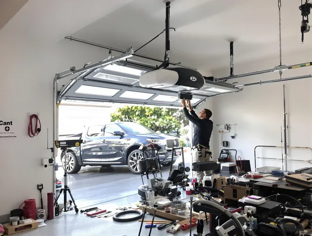 Charlotte Garage Door Repair specialist installing smart garage door opener system in Charlotte home